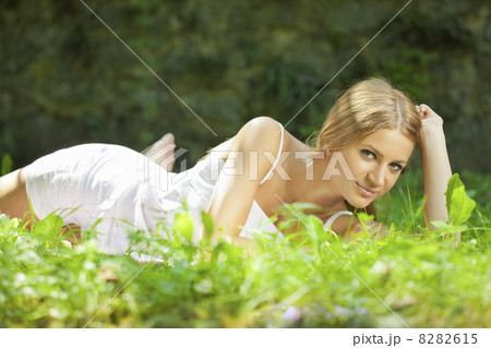 Beautiful Woman lying on the grass, rest in nature Beautiful Woman lying on the grass, rest in nature 8282615