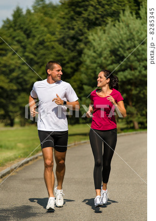 Caucasian couple running in park Caucasian couple running in park 8285345