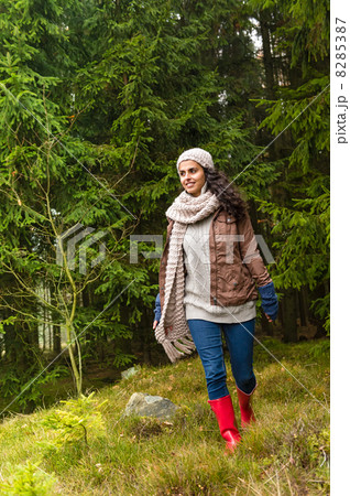 Happy woman walking in autumn forest 8285387