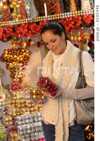 Young woman buying christmas balls in shop 8285446