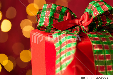 Christmas gift and sparkling lights in background Christmas gift and sparkling lights in background 8285531