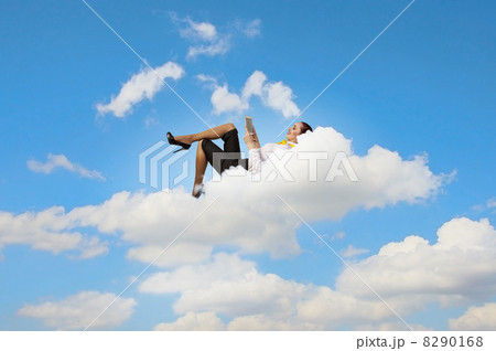 Businesswoman lying on clouds 8290168