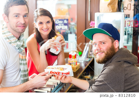 Customers eating Hotdog in fast food snack bar 8312810