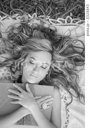 Beautiful girl with book on the grass 8328843