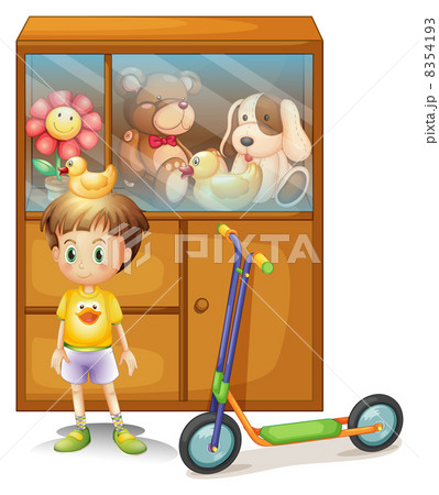 A young boy with his scooter and his toys in a cabinet 8354193