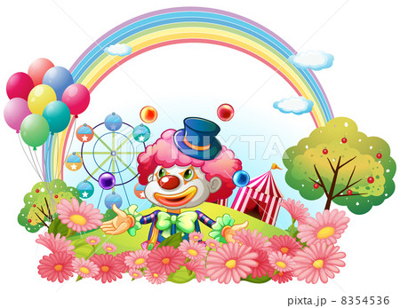 A clown in the garden with a carnival at the back 8354536