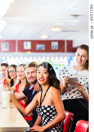 People in American diner or restaurant with milk shakes 8357194