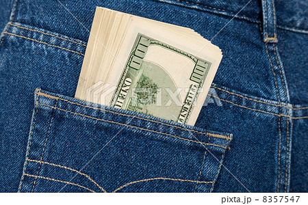 Stack of hundred dollar bills in the back jeans pocket Stack of hundred dollar bills in the back jeans pocket 8357547