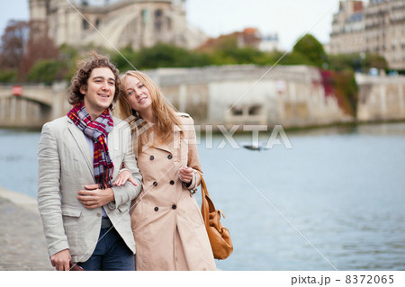 Couple walking by the Seine in Paris Couple walking by the Seine in Paris 8372065