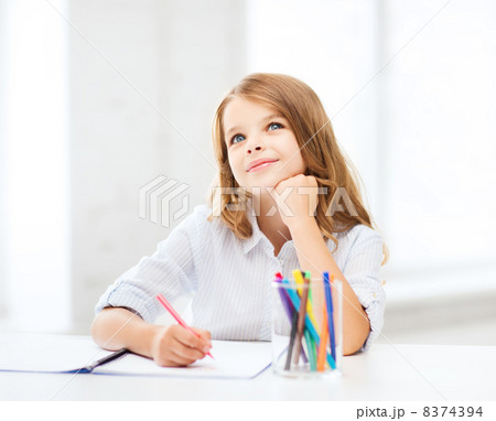 little student girl drawing at school little student girl drawing at school 8374394