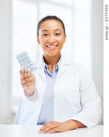doctor with blister packs of pills 8375409