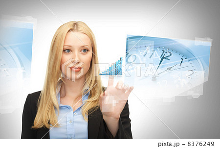 businesswoman pointing at graph clock businesswoman pointing at graph clock 8376249