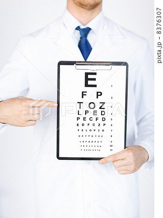 male ophthalmologist with eye chart 8376307