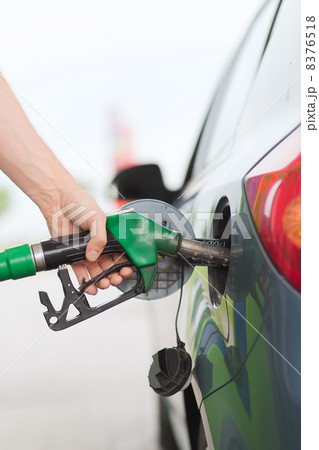 man pumping gasoline fuel in car at gas station 8376518