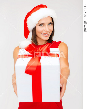 smiling woman in santa helper hat with gift box 8376519