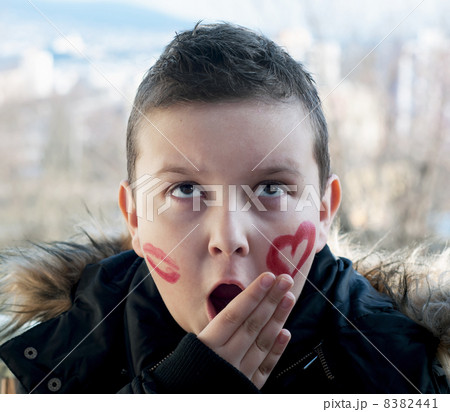 Little boy posing with painted hearts on the face Little boy posing with painted hearts on the face 8382441