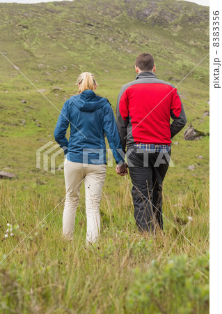 Couple holding hands and walking 8383356