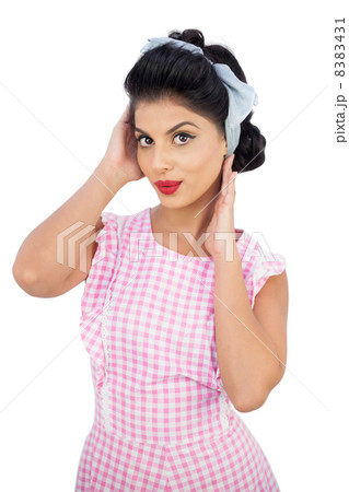 Thoughtful black hair model styling her hair Thoughtful black hair model styling her hair 8383431