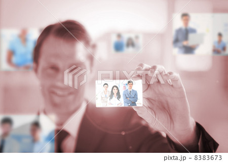 Smiling businessman picking a picture 8383673