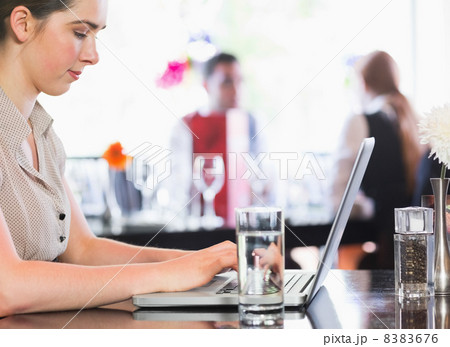 Businesswoman working on laptop 8383676