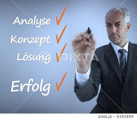 Attractive businessman writing a success checklist in german 8383899