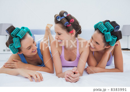 Laughing friends lying in bed Laughing friends lying in bed 8383991