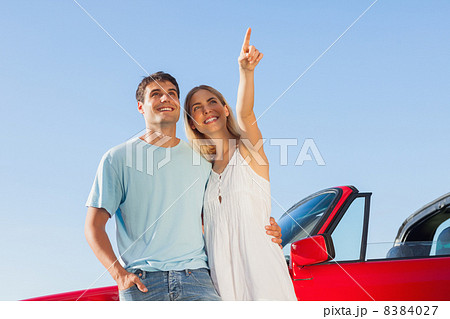 Smiling woman showing something to her handsome boyfriend 8384027