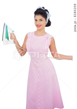 Smiling black hair model posing and holding an iron 8384209