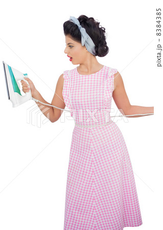 Attractive black hair model looking at an iron 8384385
