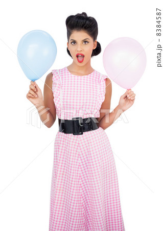 Amused black hair model holding balloons 8384587