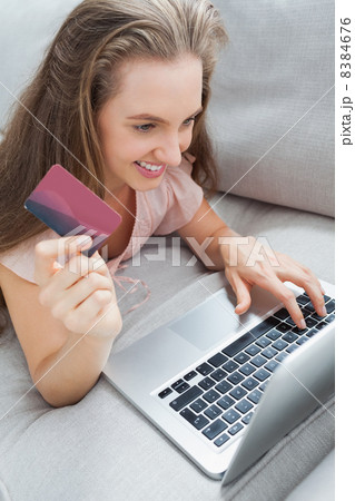 Woman shopping online on the sofa Woman shopping online on the sofa 8384676