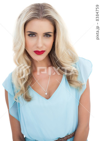 Seductive blonde model in blue dress looking at camera 8384759