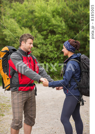 Cute couple going on a hike together holding hands 8385005