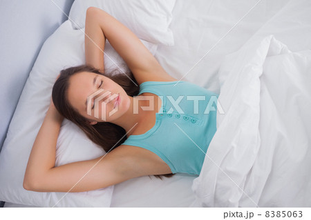 Brunette sleeping peacefully in bed 8385063