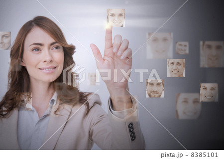Smiling businesswoman selecting digital interface Smiling businesswoman selecting digital interface 8385101