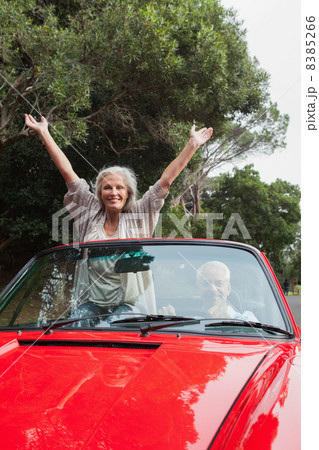 Smiling mature couple having a ride together Smiling mature couple having a ride together 8385266