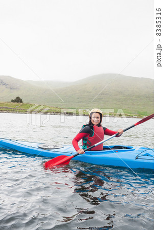 Happy woman in a kayak Happy woman in a kayak 8385316