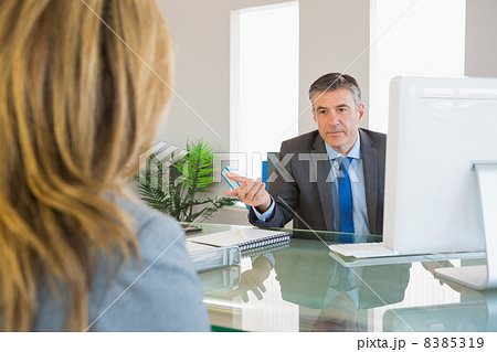 Serious businessman having a discussion with a colleague Serious businessman having a discussion with a colleague 8385319