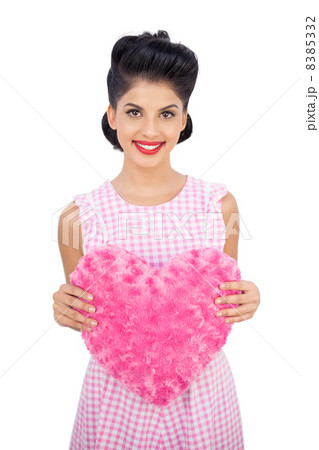Delighted black hair model holding a pink heart shaped pillow Delighted black hair model holding a pink heart shaped pillow 8385332