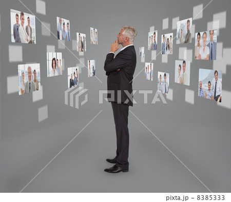 Mature businessman looking at digital interface Mature businessman looking at digital interface 8385333