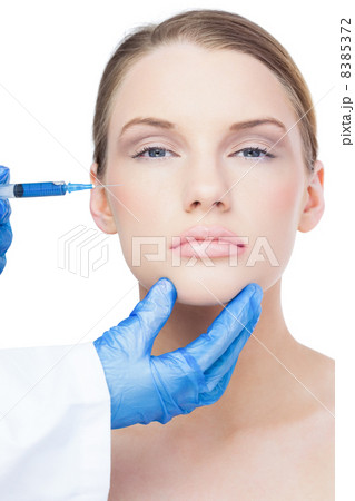 Peaceful attractive model having botox injection on the cheek 8385372