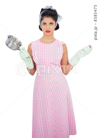 Disppointed black hair model holding a pan and wearing rubber gl 8385475