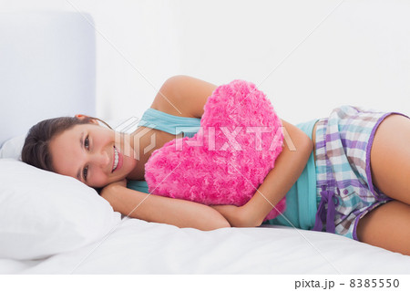 Happy woman lying in bed Happy woman lying in bed 8385550