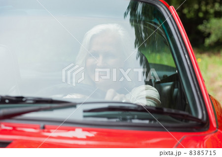 Cheerful mature woman driving red cabriolet Cheerful mature woman driving red cabriolet 8385715