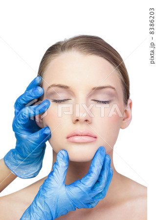 Surgeon examining peaceful gorgeous model 8386203