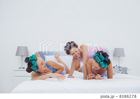 Girls in hair rollers having fun in bed Girls in hair rollers having fun in bed 8386278
