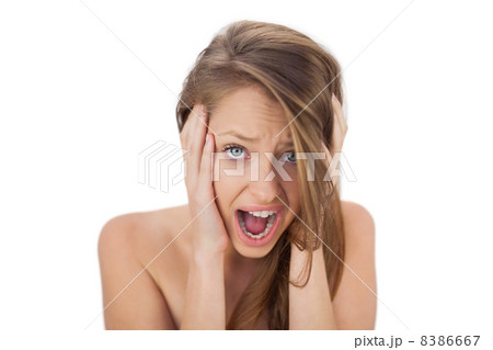Afraid brunette model holding her head and screaming Afraid brunette model holding her head and screaming 8386667