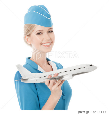 Charming Stewardess Holding Airplane In Hand. Isolated On White Charming Stewardess Holding Airplane In Hand. Isolated On White 8403143