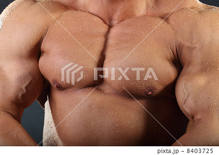 Strong chest and hand muscles of undressed tanned wet bodybuilde Strong chest and hand muscles of undressed tanned wet bodybuilde 8403725