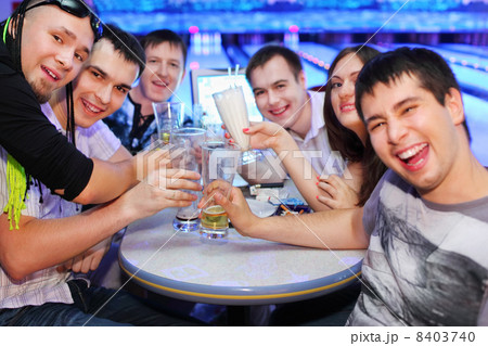 Company of happy friends sit at table and drink beer in bowling; Company of happy friends sit at table and drink beer in bowling; 8403740